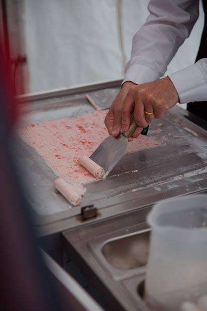 Handcrafter rolling strawberry and Meringue ice cream rolls at an exhibition