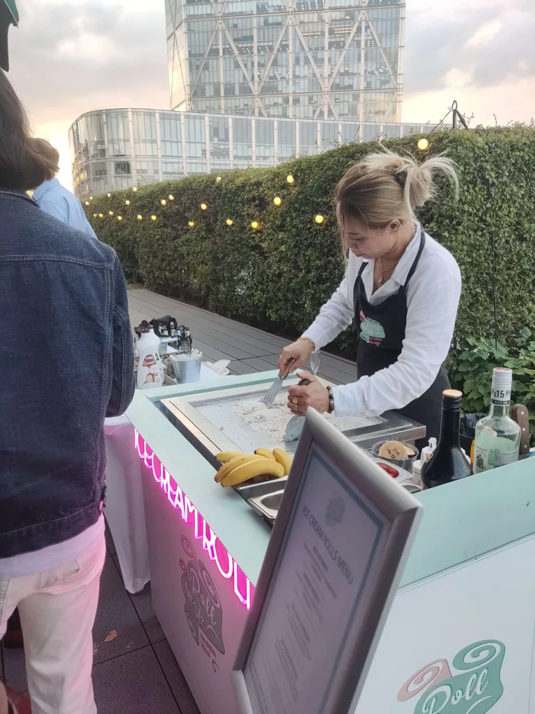 Ice cream roll crafter making ice cream rolls at a roof top party London