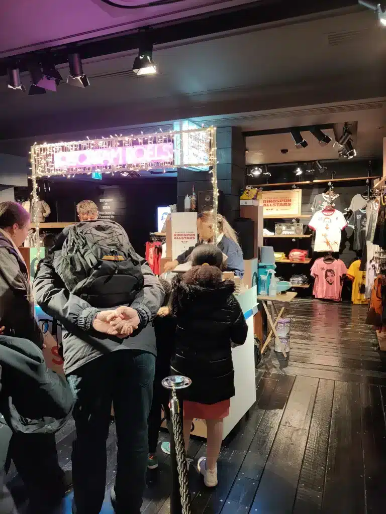Crowd gathered around a colourful ice cream roll cart at a Superdry event, enjoying custom-made ice cream rolls in a festive atmosphere